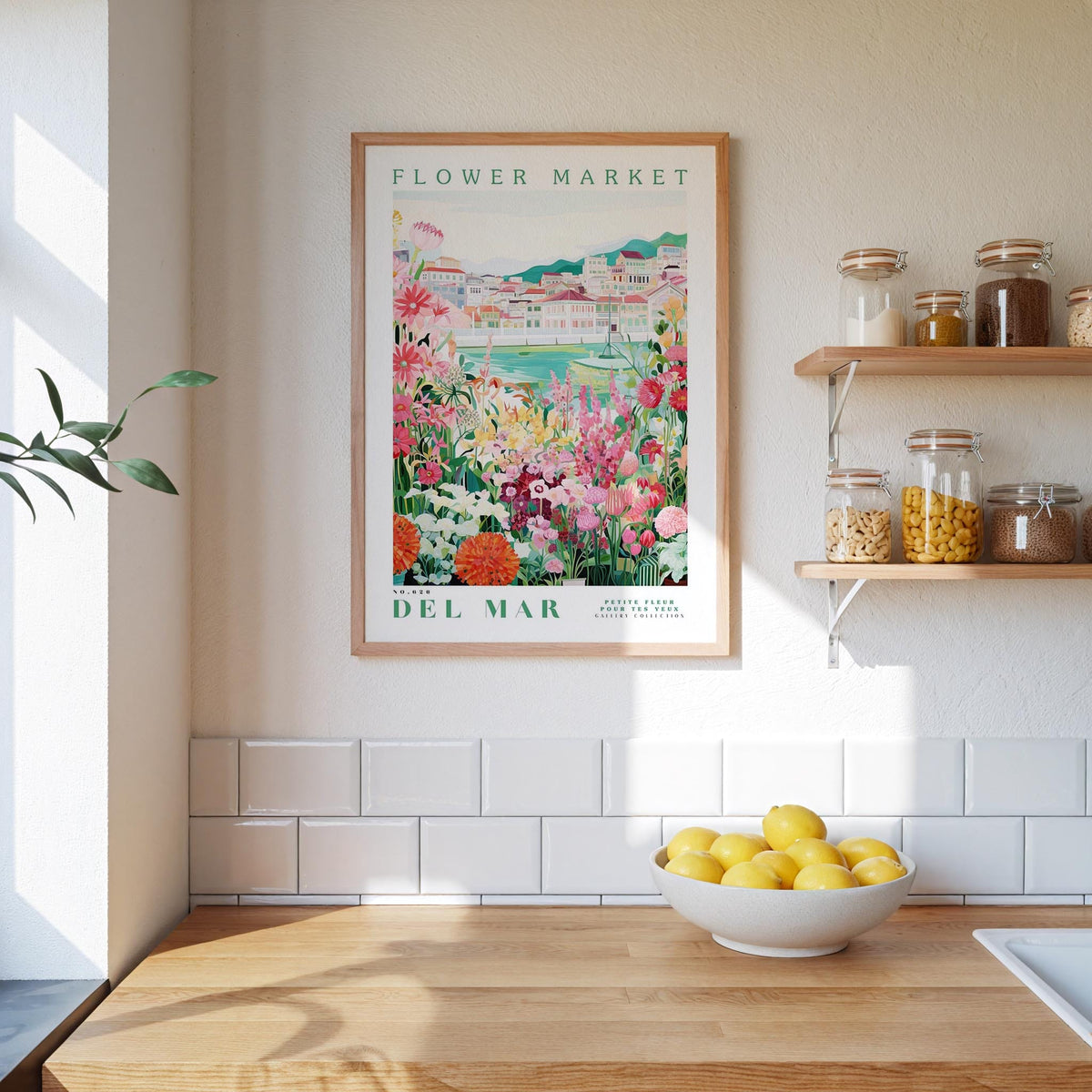 a framed poster of a flower market, a wooden counter with a bowl of lemons, and shelves with jars and containers.