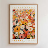 The image is a framed poster depicting a vibrant and colorful floral arrangement, with various types of flowers and foliage. The poster is titled "Flower Market Istanbul" and is framed with a wooden border.