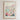 The image is a framed poster depicting a cityscape with a flower market in the background.