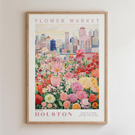 A framed poster depicting a vibrant cityscape with a variety of colorful flowers in the foreground.