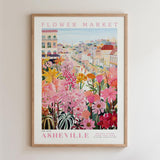 The image is a framed poster depicting a vibrant and colorful flower market in the city of Asheville, North Carolina.
