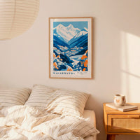 a bedroom scene with a framed poster of a mountain landscape hanging on the wall above a bed with striped bedding.