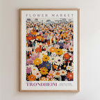 The image is a framed poster depicting a vibrant and colorful flower market scene.